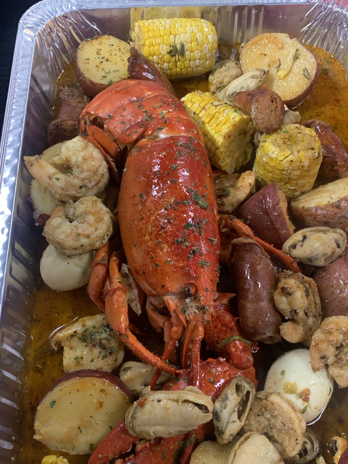 Seafood boil with lobster, shrimp, corn, and potatoes